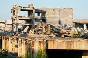 Landscape with abandoned industrial facilities under blue sky